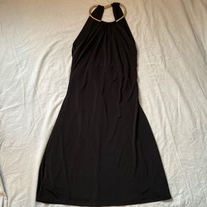 Classic LBD sleeveless backless halter style with gold necklace by Calvin Klein